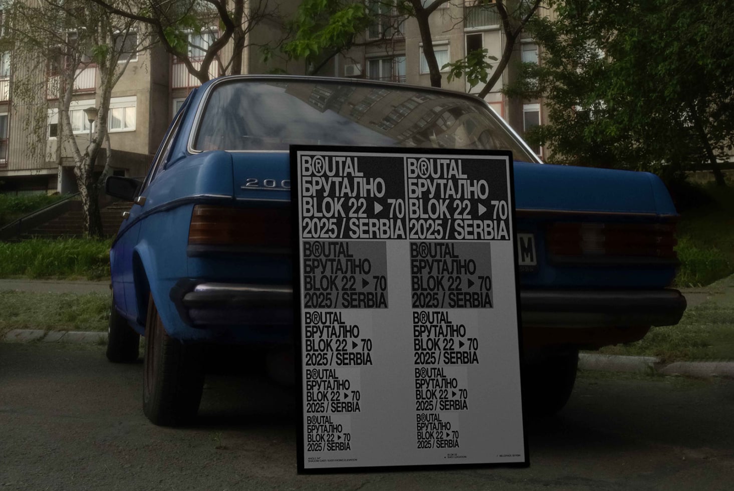 Blue 80s sedan with oversized poster mockup featuring repeating Cyrillic text