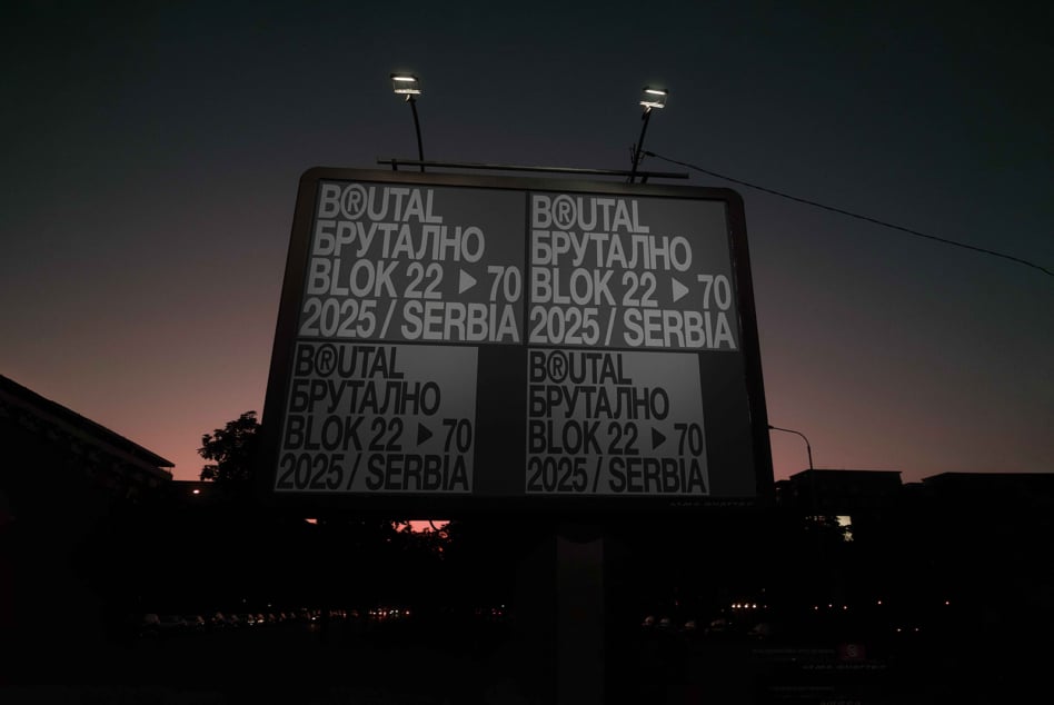 Illuminated billboard at dusk displaying four panel layout