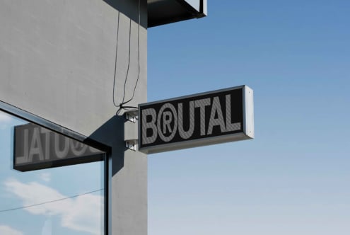 Modern storefront sign mockup reading brutal against clear sky