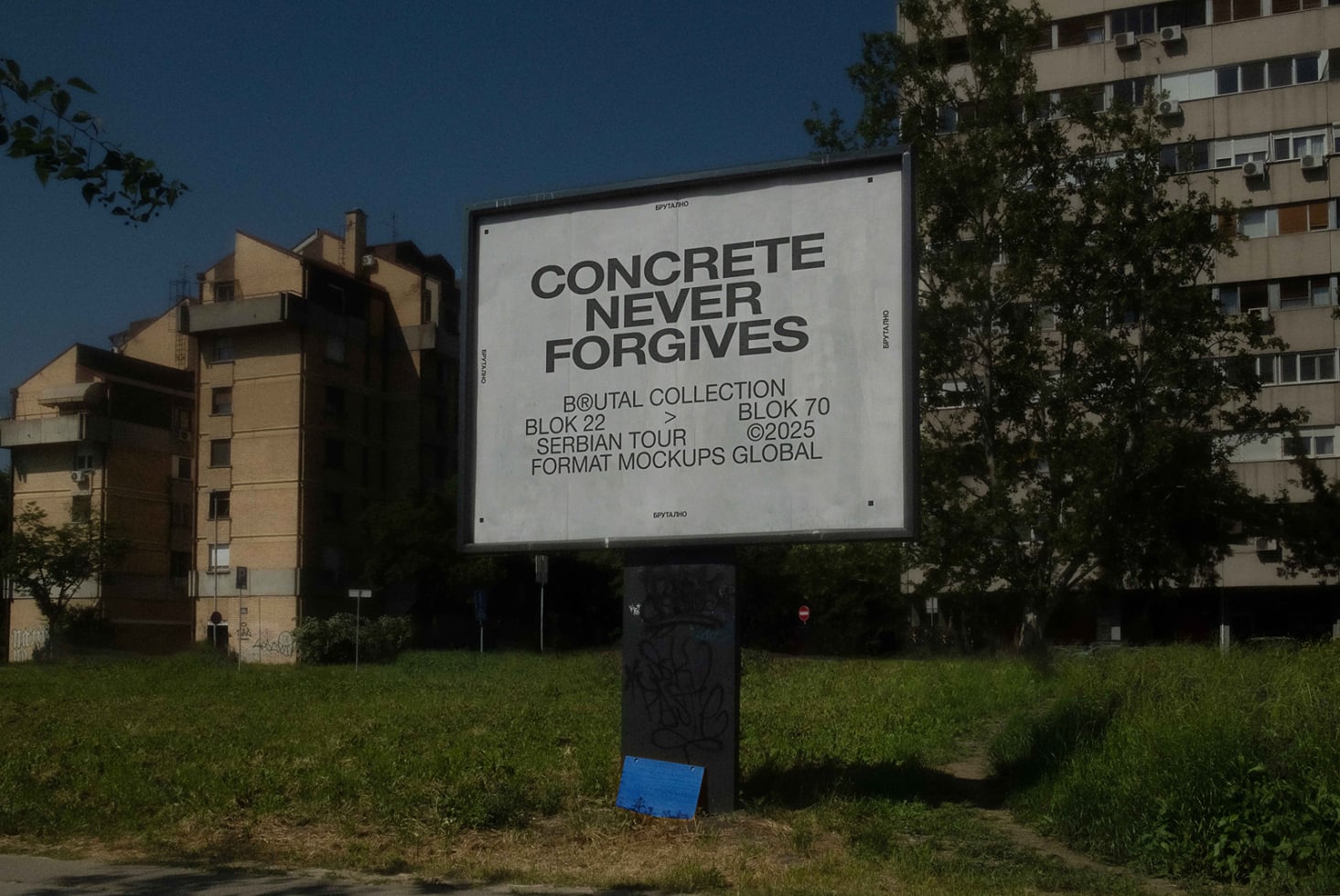 Outdoor billboard mockup with concrete never forgets text on grass