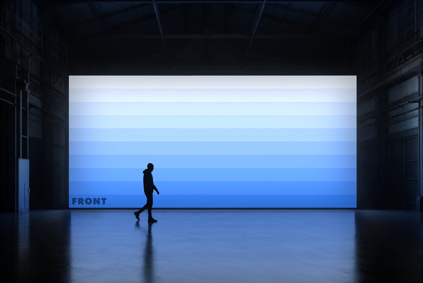 Person running past blue lit billboard in dark warehouse, minimal aesthetic