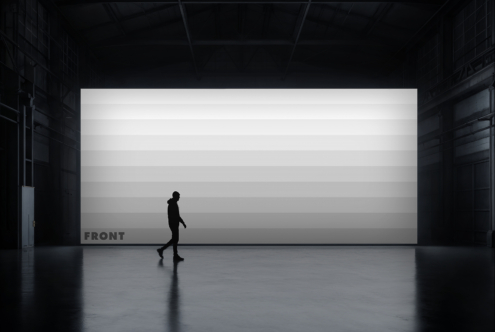Jogger moving past white billboard in concrete warehouse, dramatic overhead lighting