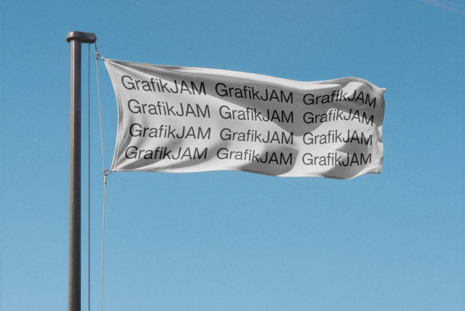 Light gray flag mockup rippling on pole with repeated text, cloudless blue sky background