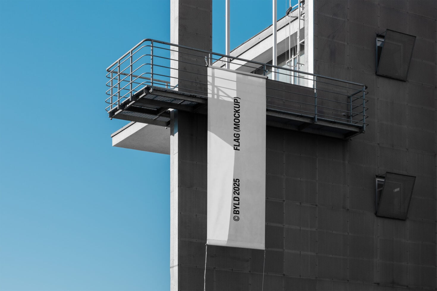 Tall building banner mockup on concrete structure against blue sky