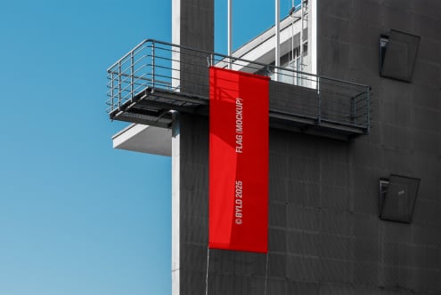 Vertical banner flag mockup in bright red on contemporary architecture facade