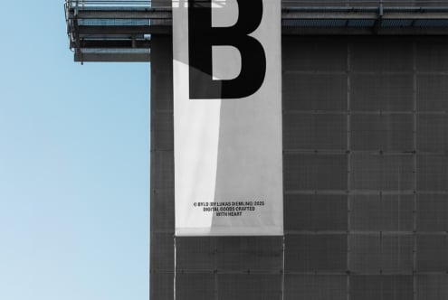 Black B letter on split white gray background banner on industrial facade