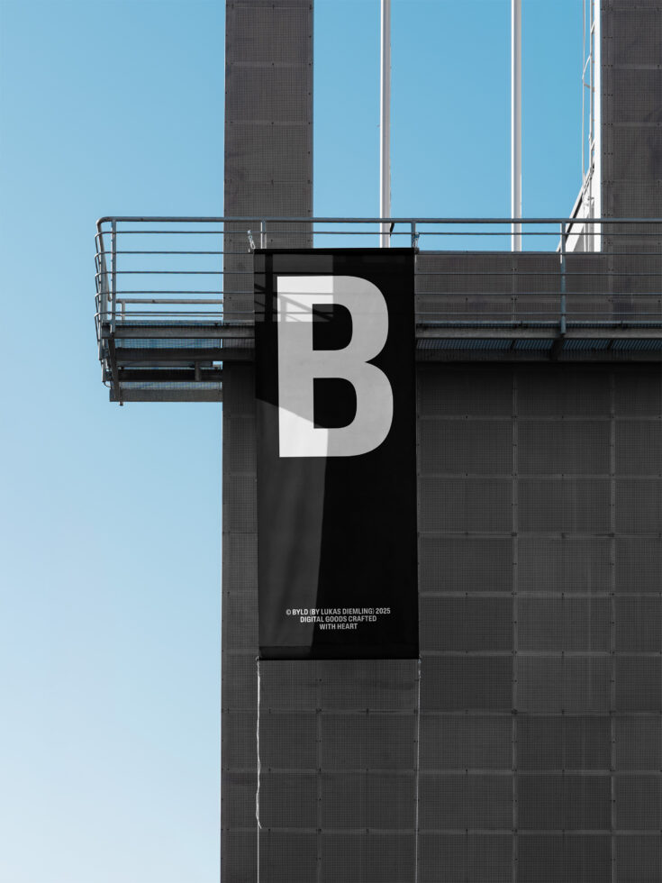 Black banner with white B letter hanging on industrial building against blue sky