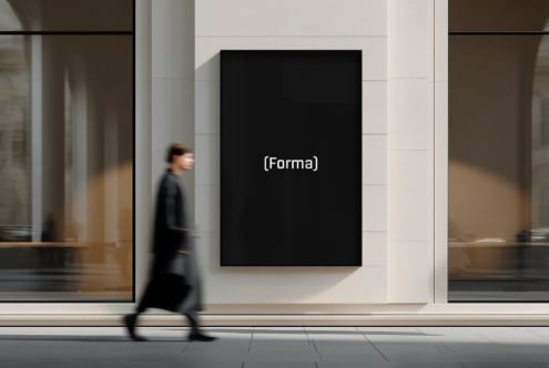 Large black rectangle display on white tiled wall with passing pedestrian