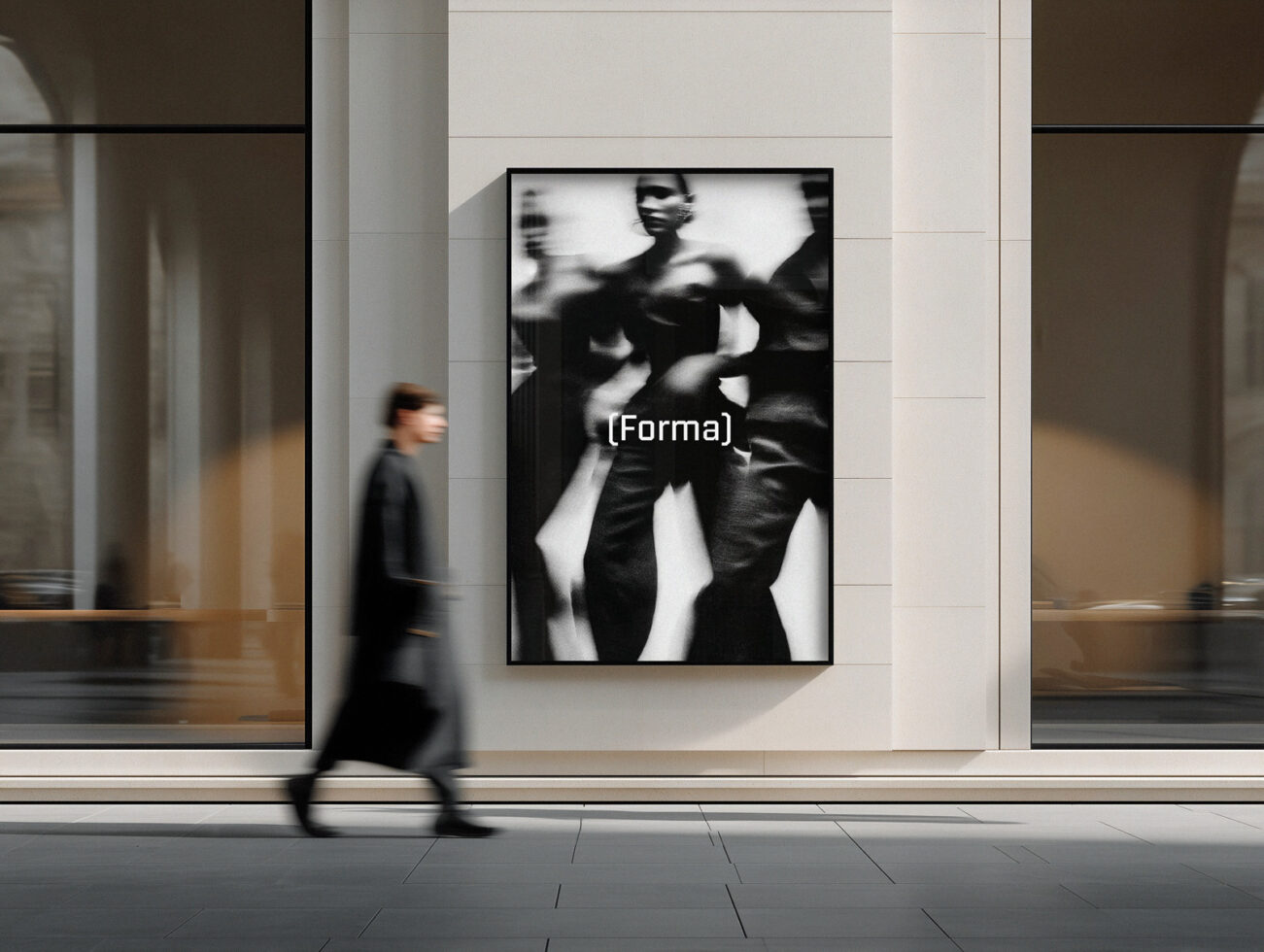 Urban storefront with blurred figure walking past framed black white photography