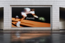 Blurred motion of skateboarder on orange ramp against dark background