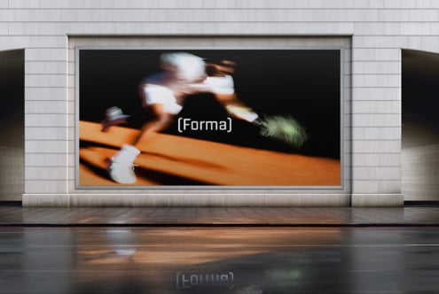 Blurred motion of skateboarder on orange ramp against dark background