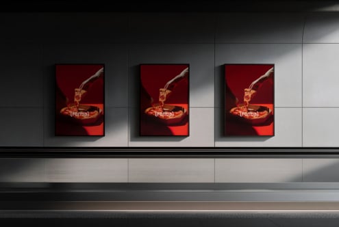 Three framed posters of liquid splash artwork hung on white wall