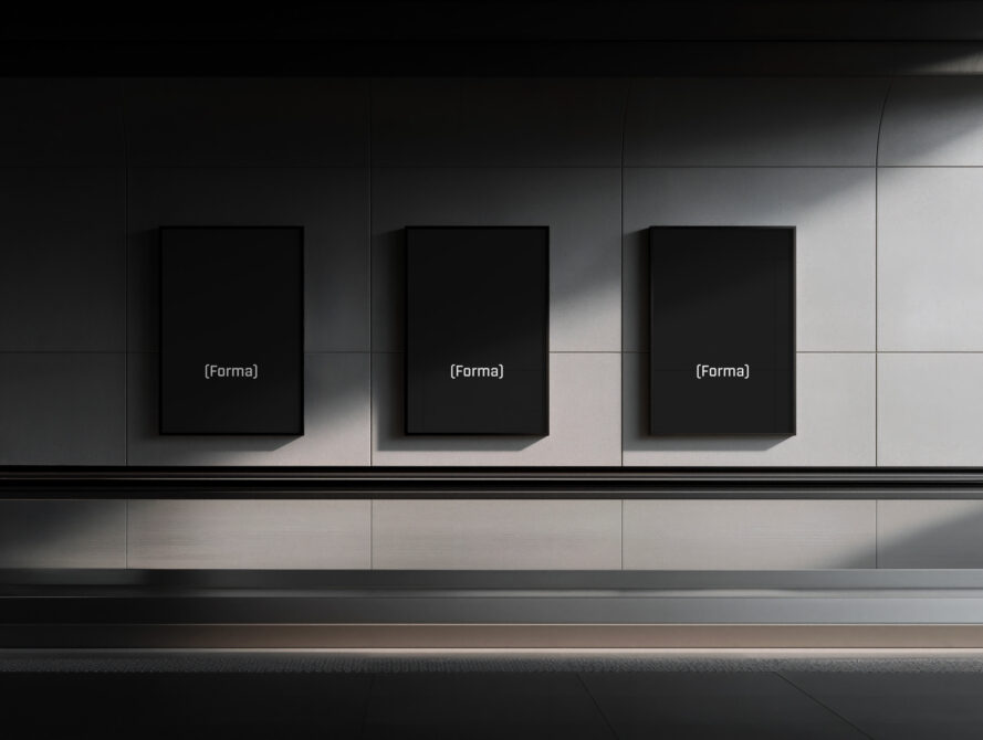 Three black square frames displayed on concrete gallery wall