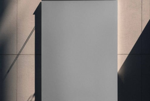 Blank poster mockup on textured wall with dramatic shadow overlay from railing