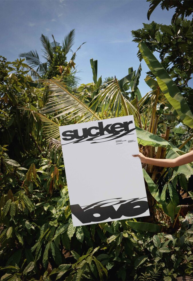 White letterhead with sucker branding held up in lush tropical plant setting