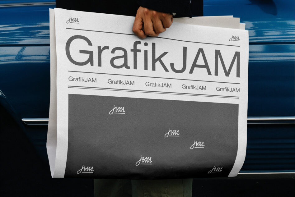 White rolled poster mockup with large text held up by person in front of blue vehicle