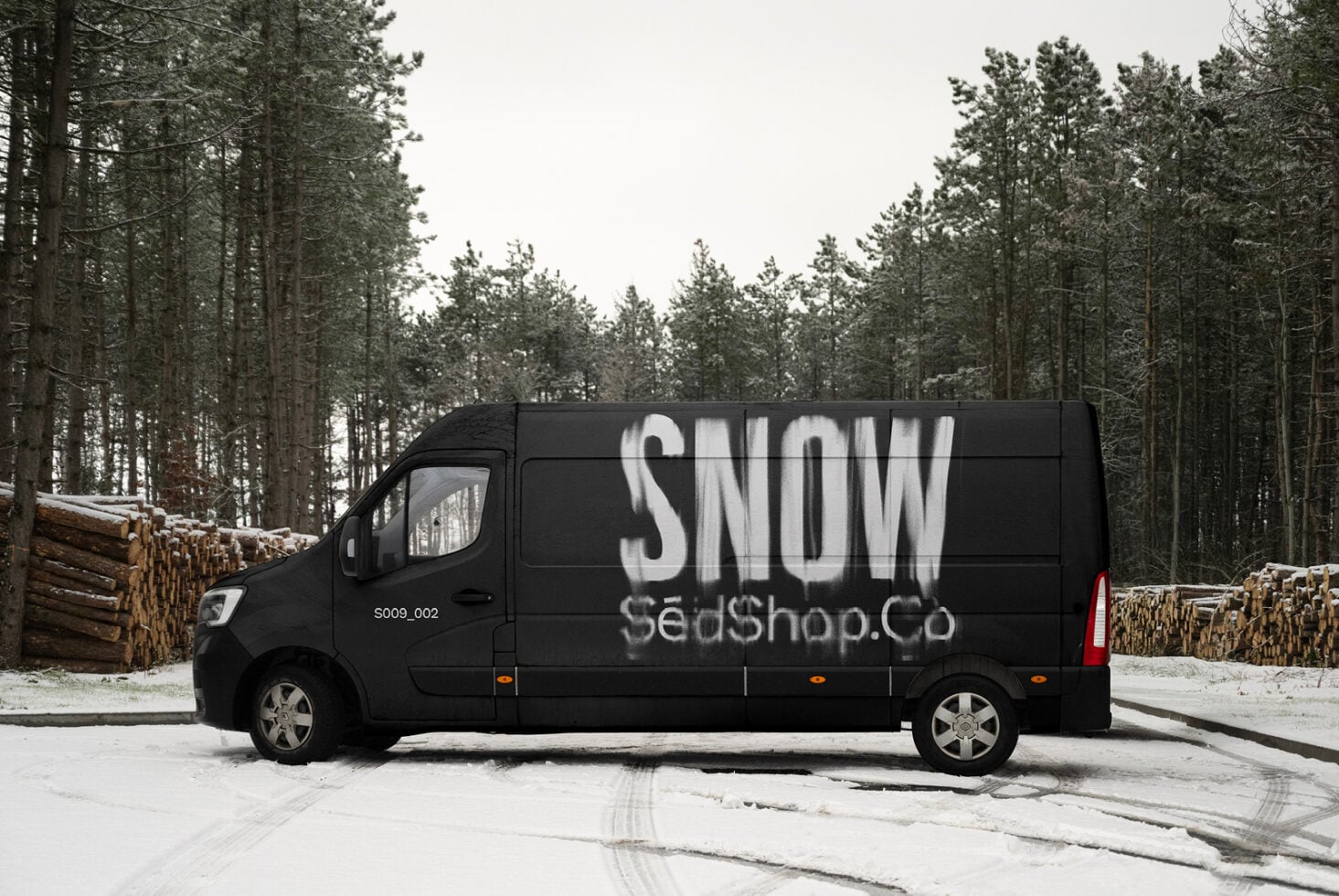 Black delivery van with SNOW lettering in white spray paint on side panel