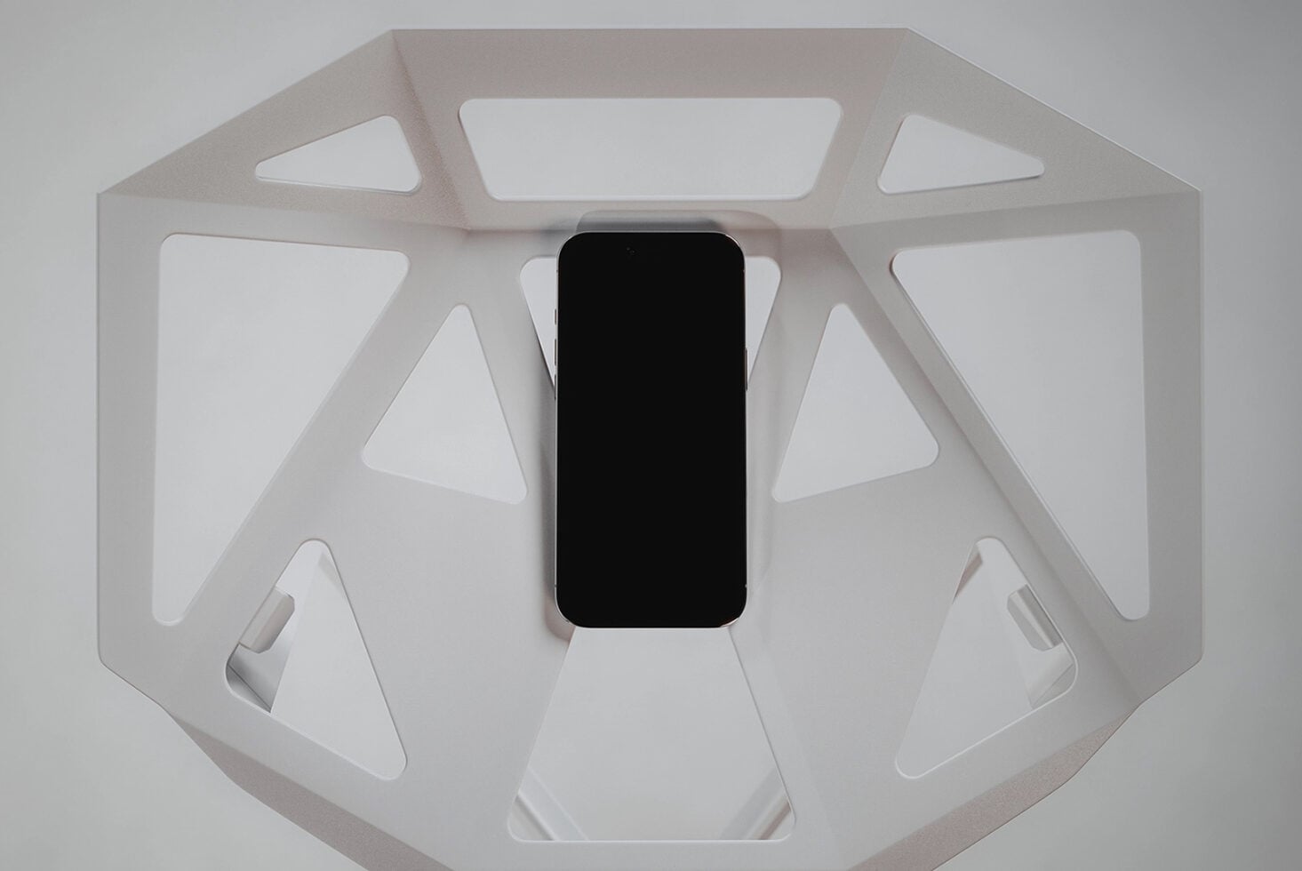Overhead shot of phone with blank screen in white octagonal product showcase box