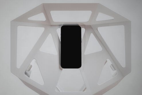 Overhead shot of phone with blank screen in white octagonal product showcase box
