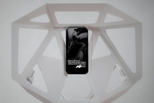 Phone displaying motion design inside white octagonal display box from above