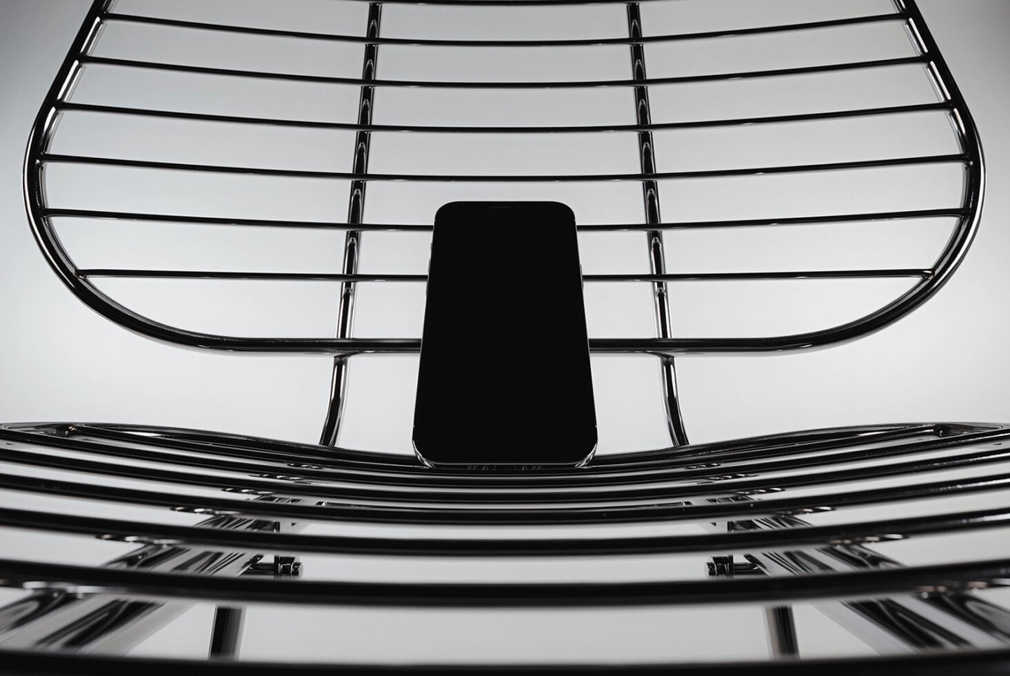 Smartphone mockup positioned on metal grille structure overhead view