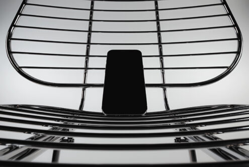 Smartphone mockup positioned on metal grille structure overhead view