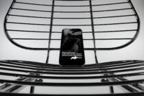 Mobile phone mockup on geometric metal grid with clean spacing