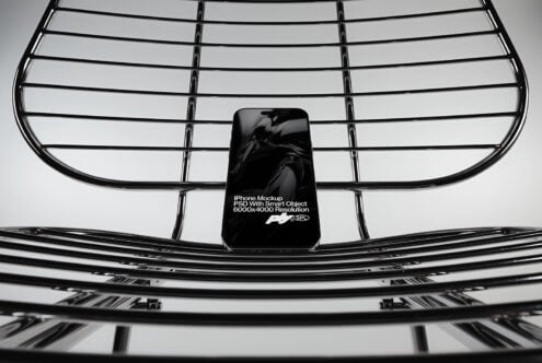 Mobile phone mockup on geometric metal grid with clean spacing
