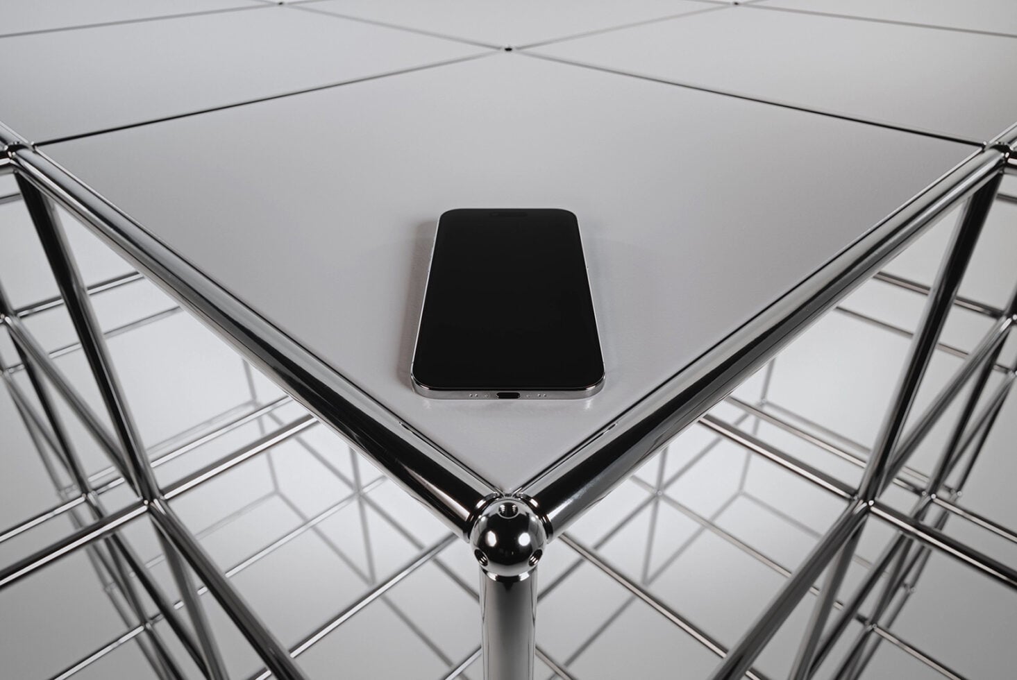 Dark smartphone centered on grid ceiling with chrome geometric frames