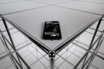 iPhone centered on geometric grid platform with symmetrical metal framework