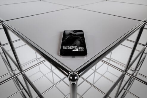iPhone centered on geometric grid platform with symmetrical metal framework