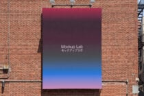 Wall banner with gradient from maroon to pink purple on brick facade