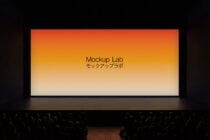 Theater screen displaying orange to cream gradient with centered text, audience visible