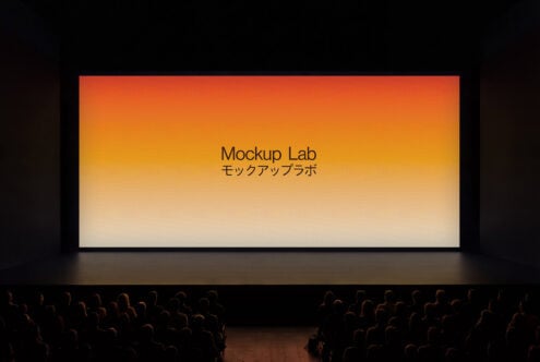Theater screen displaying orange to cream gradient with centered text, audience visible