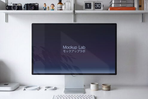 Desktop workspace with monitor displaying dark blue gradient, keyboard, desk accessories