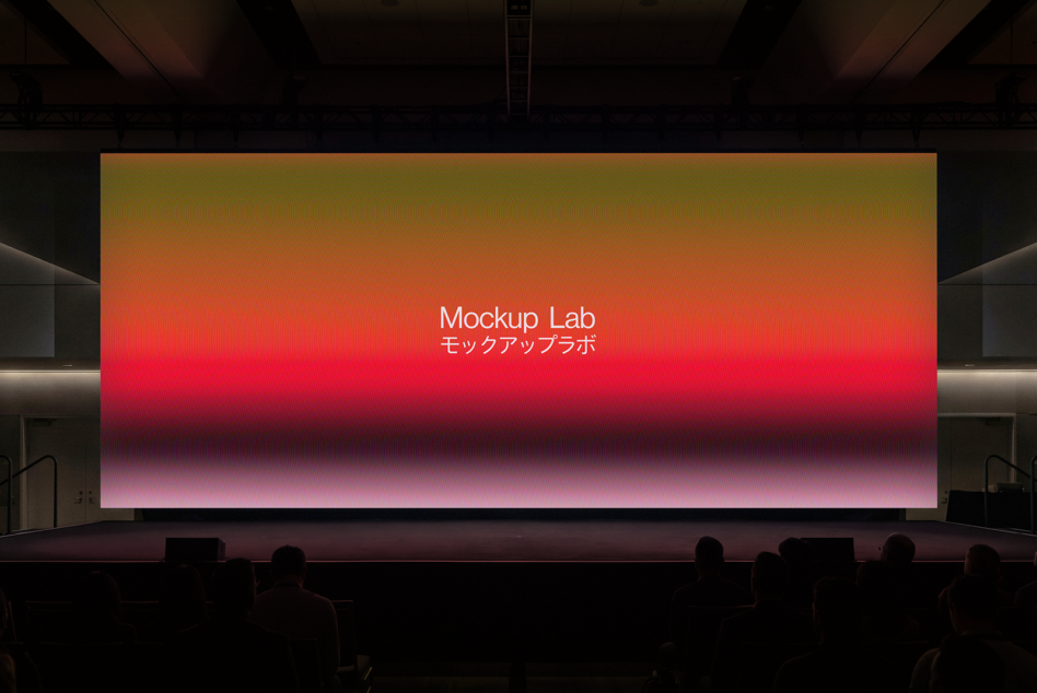 Large cinema screen displaying gradient from orange to pink with Mockup Lab text