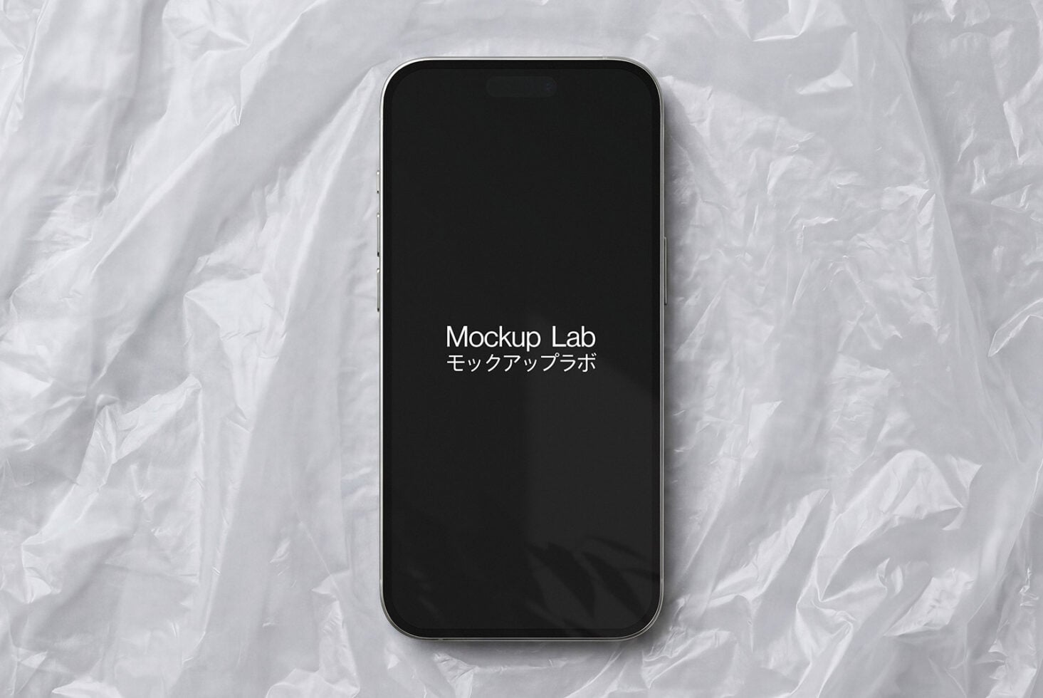 iPhone 14 Pro with black screen displaying Mockup Lab text on white textured background