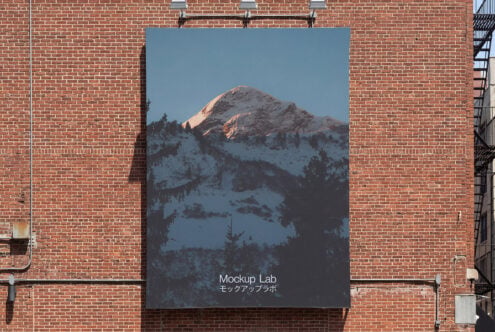 Large poster on exposed brick showing snow covered mountain landscape