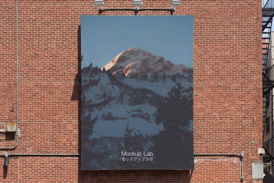 Large poster on exposed brick showing snow covered mountain landscape