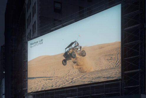 Wide urban LED display with soft gradient colors, repeated text pattern at dusk