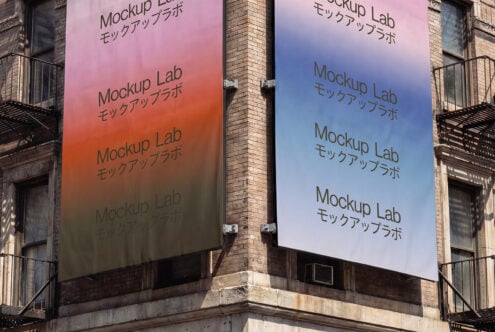 Street banners on brick column displaying pink orange blue color shifts