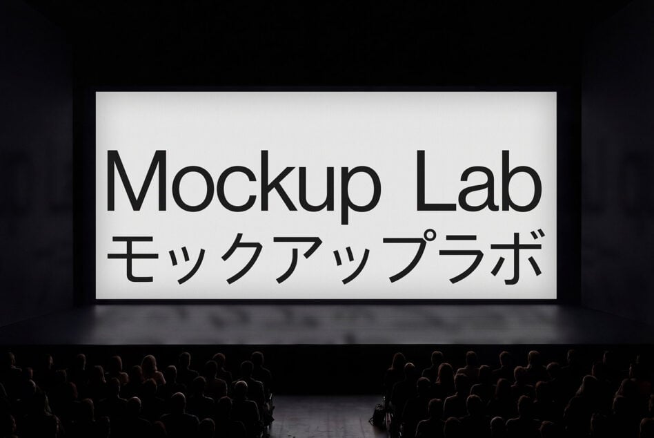 Large theater projection screen with bold black text on white, crowd silhouettes below