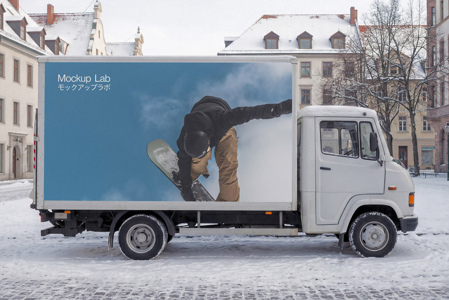 White truck cargo box with snowboarder photo against blue sky in snowy town square