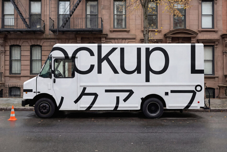 White box truck with large black typography mockup against brownstone