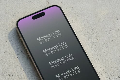 Phone on concrete surface with purple to gray gradient screen visible