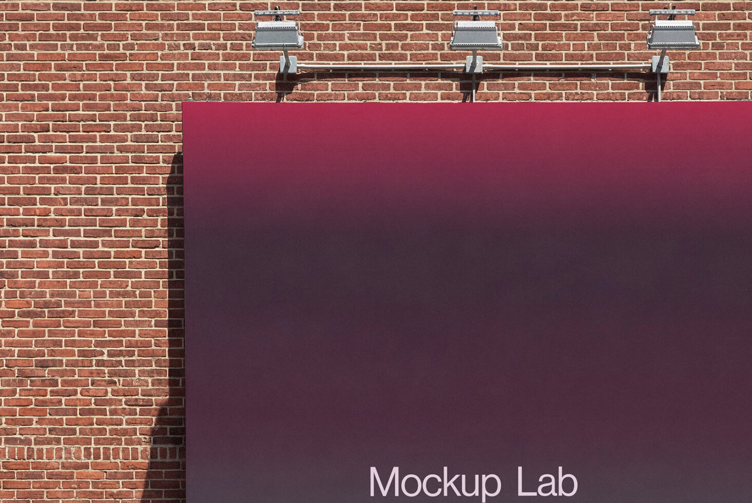 Burgundy poster hanging on red brick wall with metal clamps