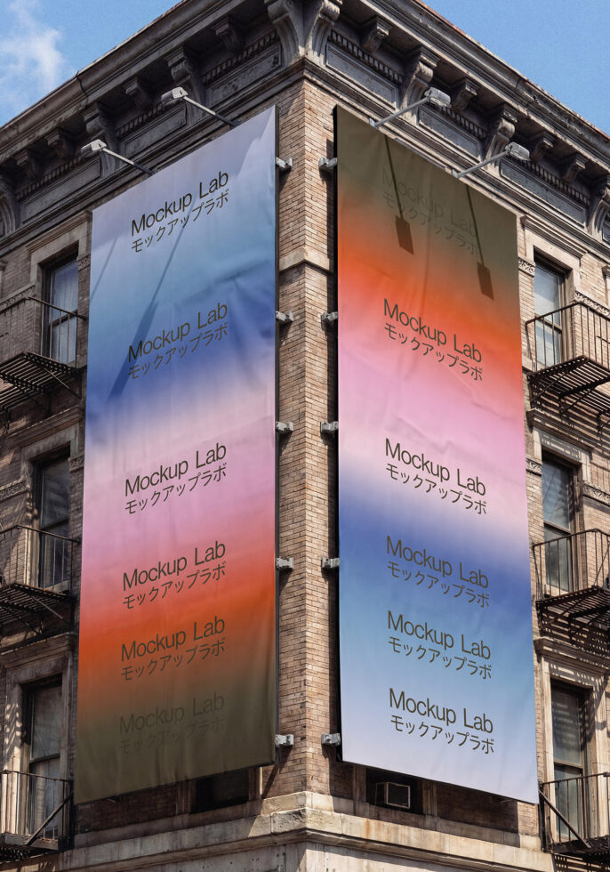 Two tall street banners on historic building corner with gradient overlays
