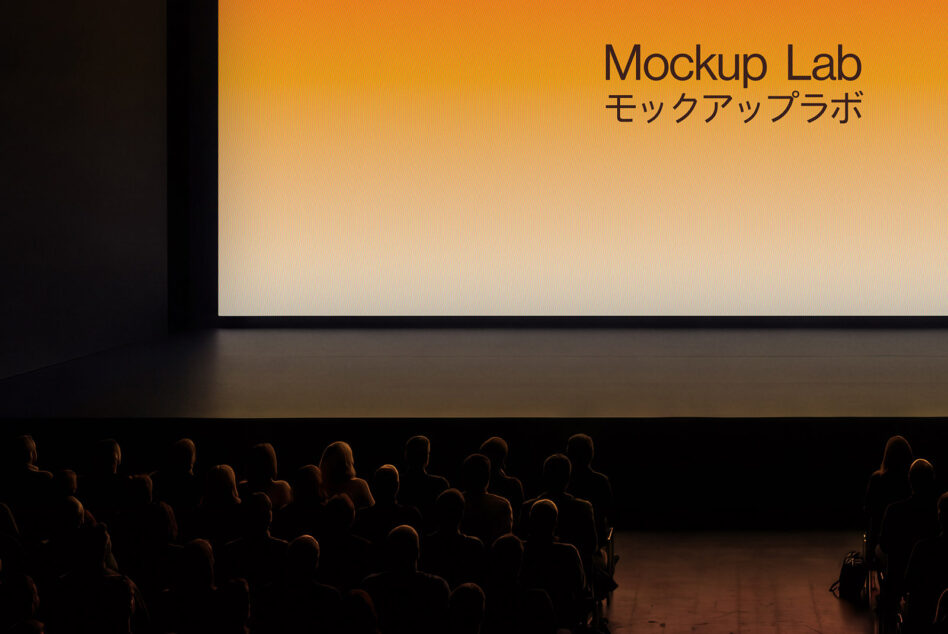 Movie theater screen showing orange gradient with text, silhouetted audience below
