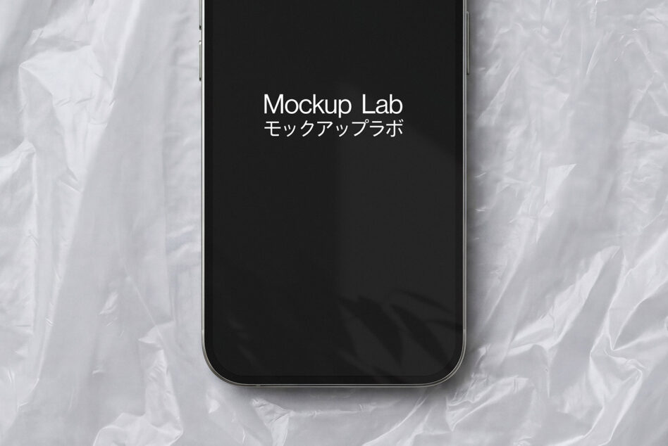 iPhone 14 Pro in black with Mockup Lab text on dark screen against white marble