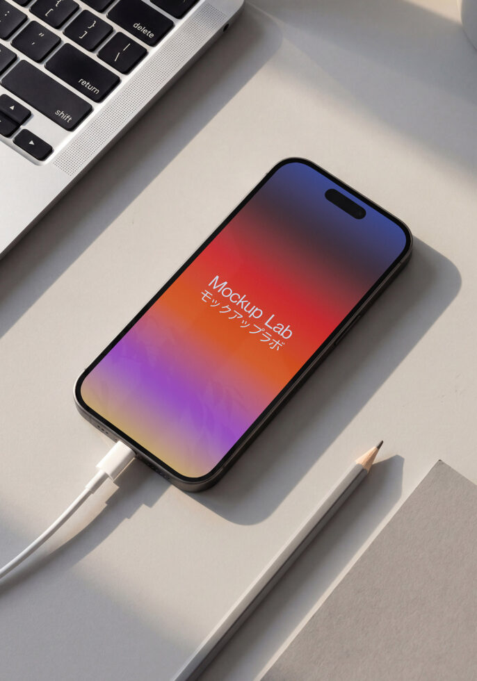 Overhead shot of phone on desk with colorful gradient from red to purple